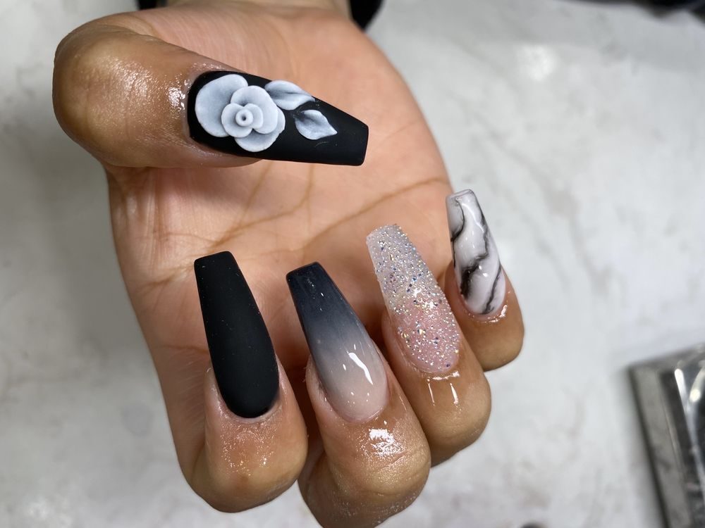 Long black matte nails with white 3D flowers, ombré, glitter and marble designs by J Nail Spa